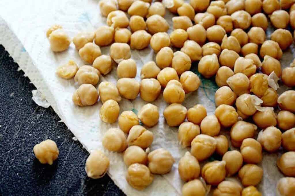A close-up view of cooked chickpeas in a pot, a versatile ingredient in culinary dishes